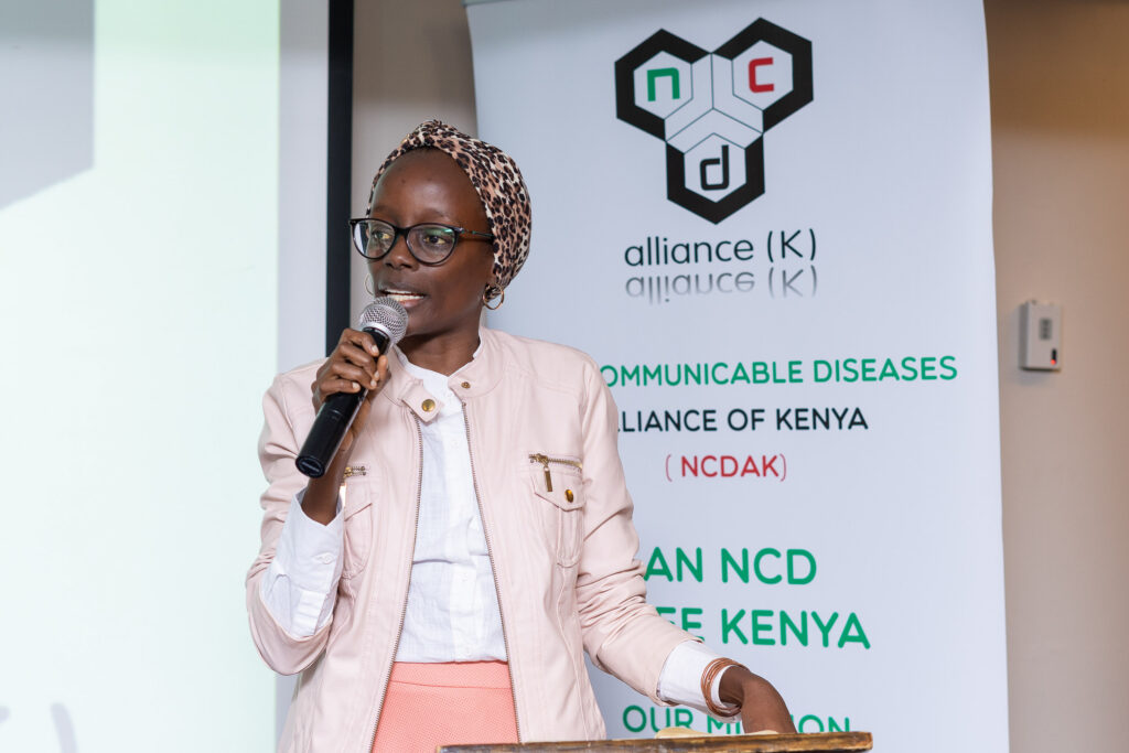 Speaker addressing delegates from a lectern at an NCD Alliance of Kenya event