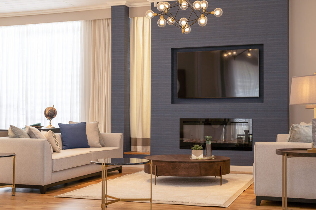 Contemporary living room with a fireplace feature wall and cream sofas