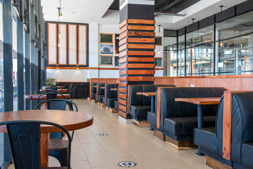 Restaurant interior with booth seating and brick pillars
