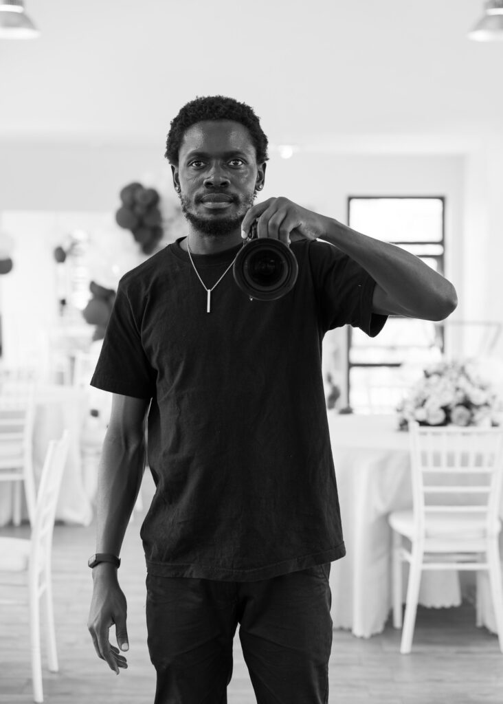Photographer Arnold Julian holding a camera at an event venue
