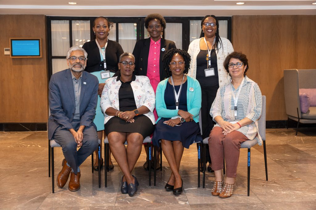 Delegates posing for a group photograph indoors