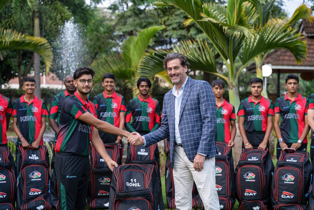 Team member shaking hands with a sponsor at a kit handover