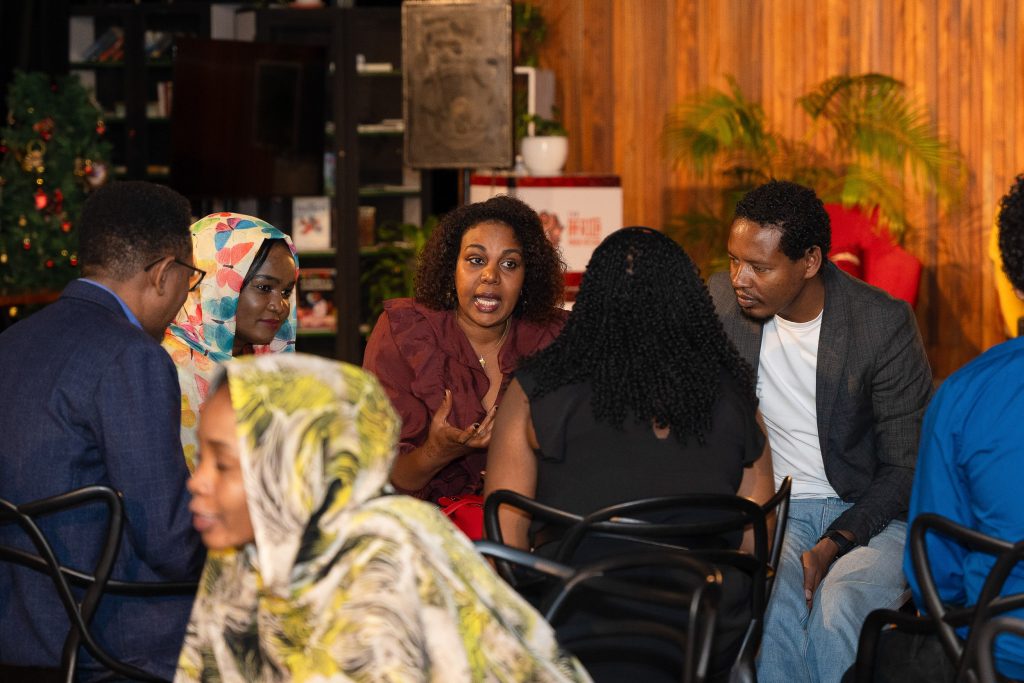 Guests seated in conversation at an indoor gathering