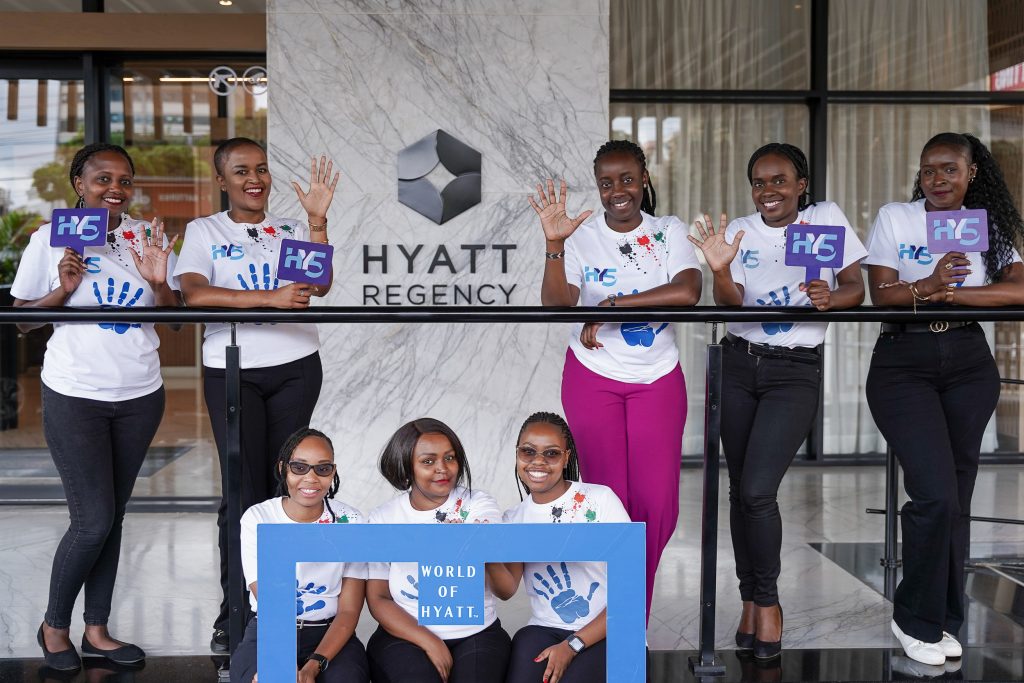 Group holding signs at a corporate event at Hyatt Regency
