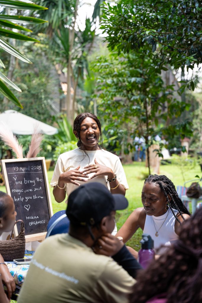 Facilitator speaking to a seated group at an outdoor garden workshop