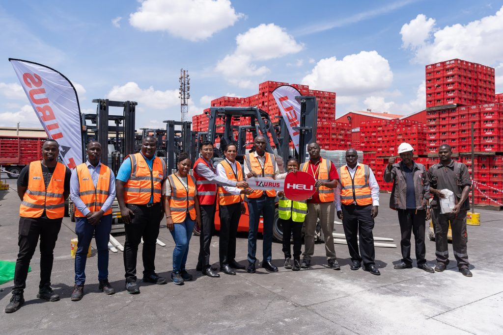 Group in high visibility vests photographed at an industrial site with stacked red crates
